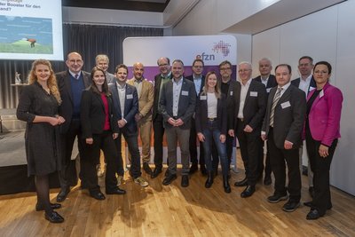 Menschen vor einer Wand mit der Aufschrift "Niedersäcsische Energietage"