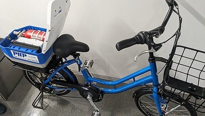 Ein Fahrrad mit einer Schachtel, die 2 Brennstoffzellen enthält, die mit einer Brennstoffart betrieben werden
